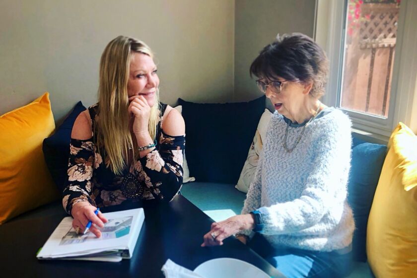 Designer Karen Kelly (left) offers design advice to Julie Alberti during ASID San Diego's Summer Spruce Up fundraiser. Now through Aug. 31, consumers can arrange for an in-home design consultation from American Society of Interior Designers members.