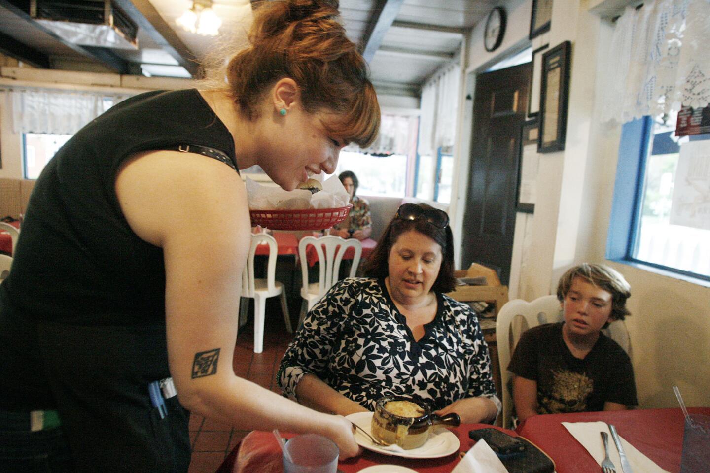 Waitress Katie Canavan, from left, servers her customers Stephanie Patterson and her son, Griffin Kazanegras, 11, at Riverside Cafe in Burbank on Wednesday, August 22, 2012.