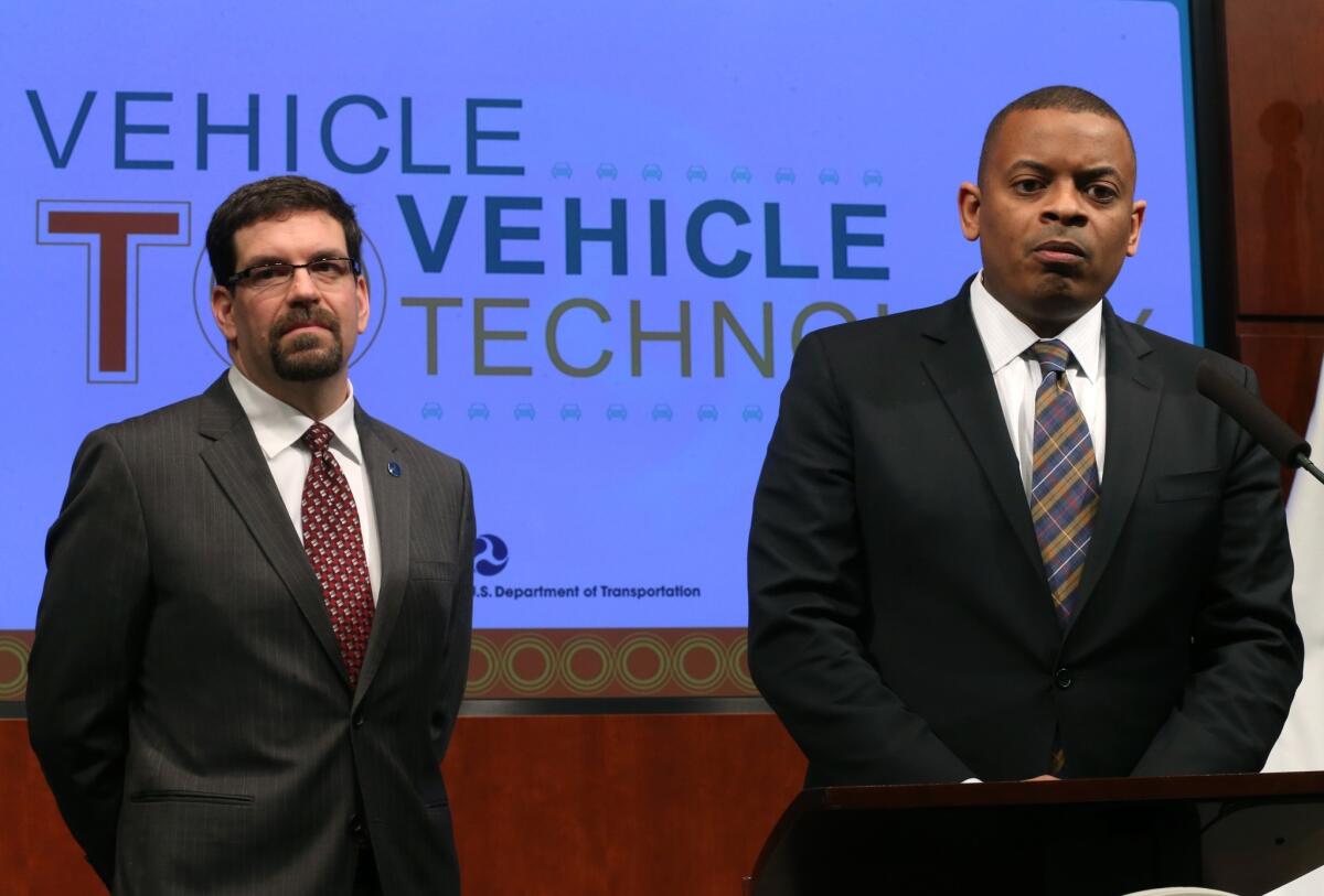 David Friedman, left, acting administrator of the National Highway Traffic Safety Administration, and Transportation Secretary Anthony Foxx listen to questions during a news conference on automobile safety.