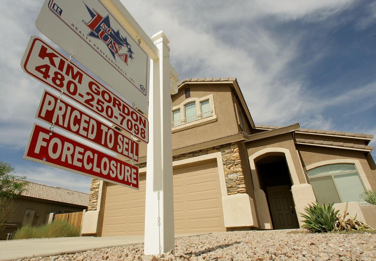 Foreclosure filings fell 15% in November, reaching a seven-year low, according to Realtytrac. Above, a 2007 file photo shows a home in foreclosure in Queen Creek, Ariz.