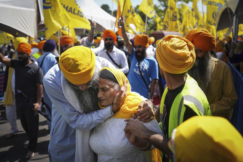 FILE - A woman is consoled as people mourn Sikh community leader and temple president Hardeep Singh Nijjar during Antim Darshan, the first part of day-long funeral services for him, in Surrey, British Columbia, Sunday, June 25, 2023. Nijjar was gunned down in his vehicle while leaving the Guru Nanak Sikh Gurdwara Sahib parking lot. The September 2023 accusation by Canadian Prime Minister Justin Trudeau that India may have been behind the assassination of Nijjar, a Sikh separatist leader, has raised several complex questions about the nature of Sikh activism in the North American diaspora. (Darryl Dyck/The Canadian Press via AP, File)