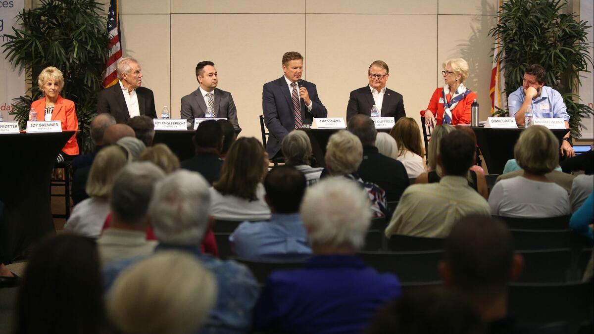 Candidate Tim Stoaks, center, makes a comment during opening statements of the first 2018 Newport Beach City Council candidate forums at the Newport Beach Central Library.