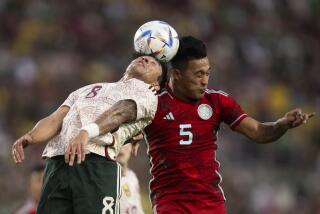 Mexico midfielder Omar Govea (8) and Colombia midfielder Sebastián Gómez (5) vie for a head ball.