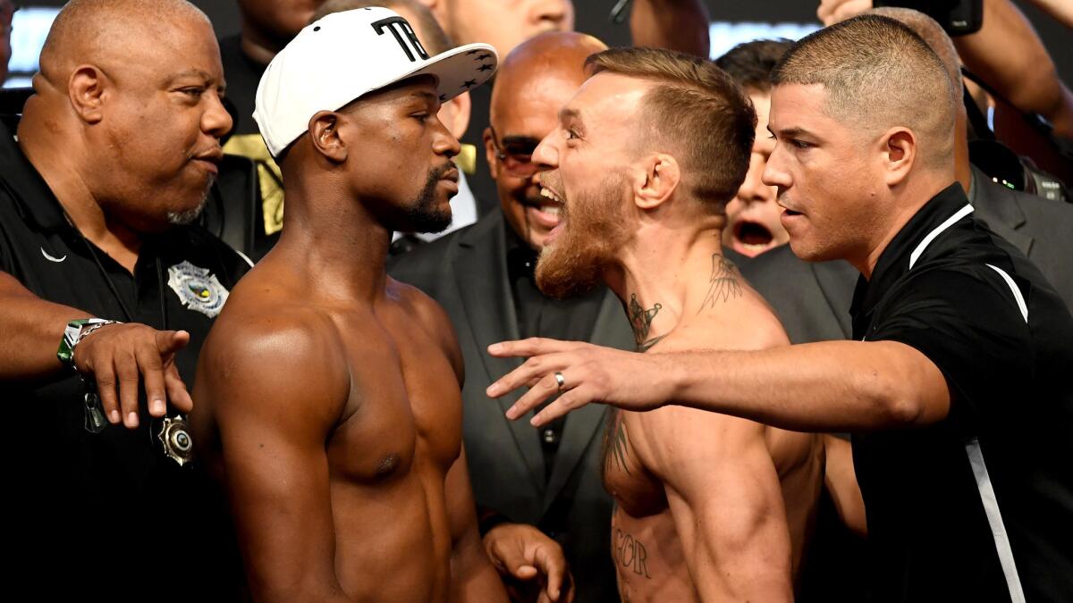 Floyd Mayweather Jr. and Conor McGregor face off after they weighed in Friday.