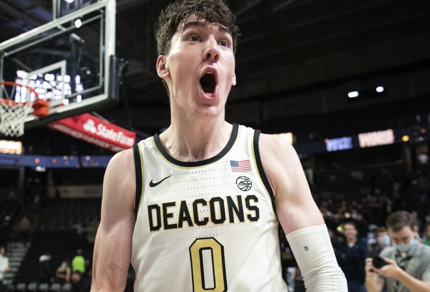 Wake Forest forward Jake Laravia (0) celebrates after the team's overtime victory over Northwestern during an NCAA college basketball game Tuesday, Nov. 30, 2021, in Winston-Salem, N.C. (Allison Lee Isley/The Winston-Salem Journal via AP)