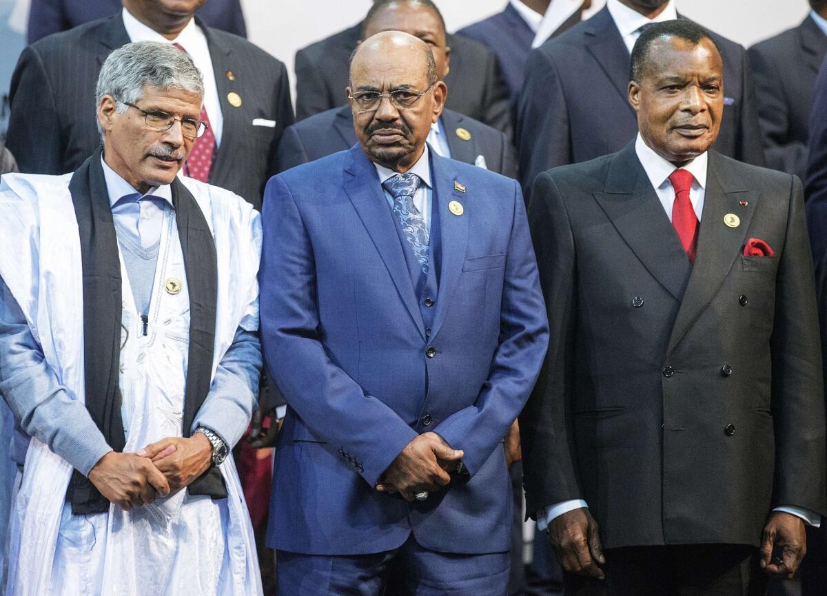Abdelkader Taleb Oumar, prime minister of the Sahrawi Arab Democratic Republic, left, poses with Sudan's president, Omar Bashir, and Congo's president, Denis Sasso-Nguesso, at the 25th African Union summit in South Africa on Sunday. The International Criminal Court has ordered South Africa not to let Bashir leave the country.