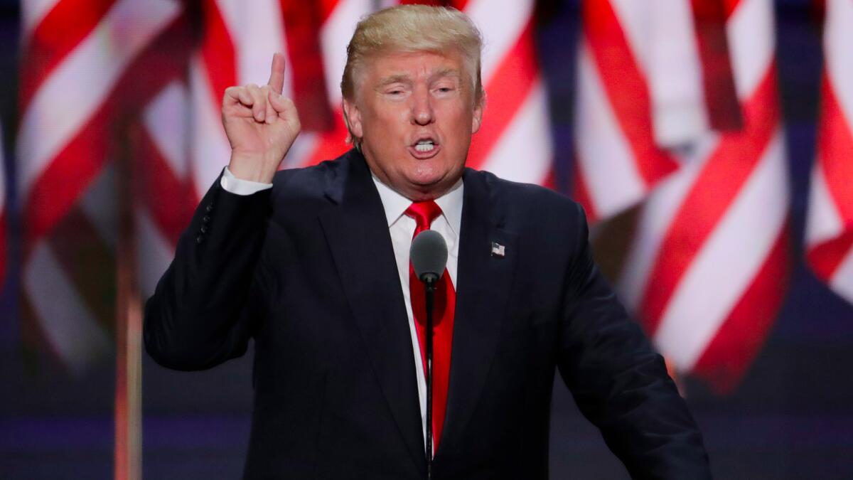 President Trump speaking before an array of American flags.