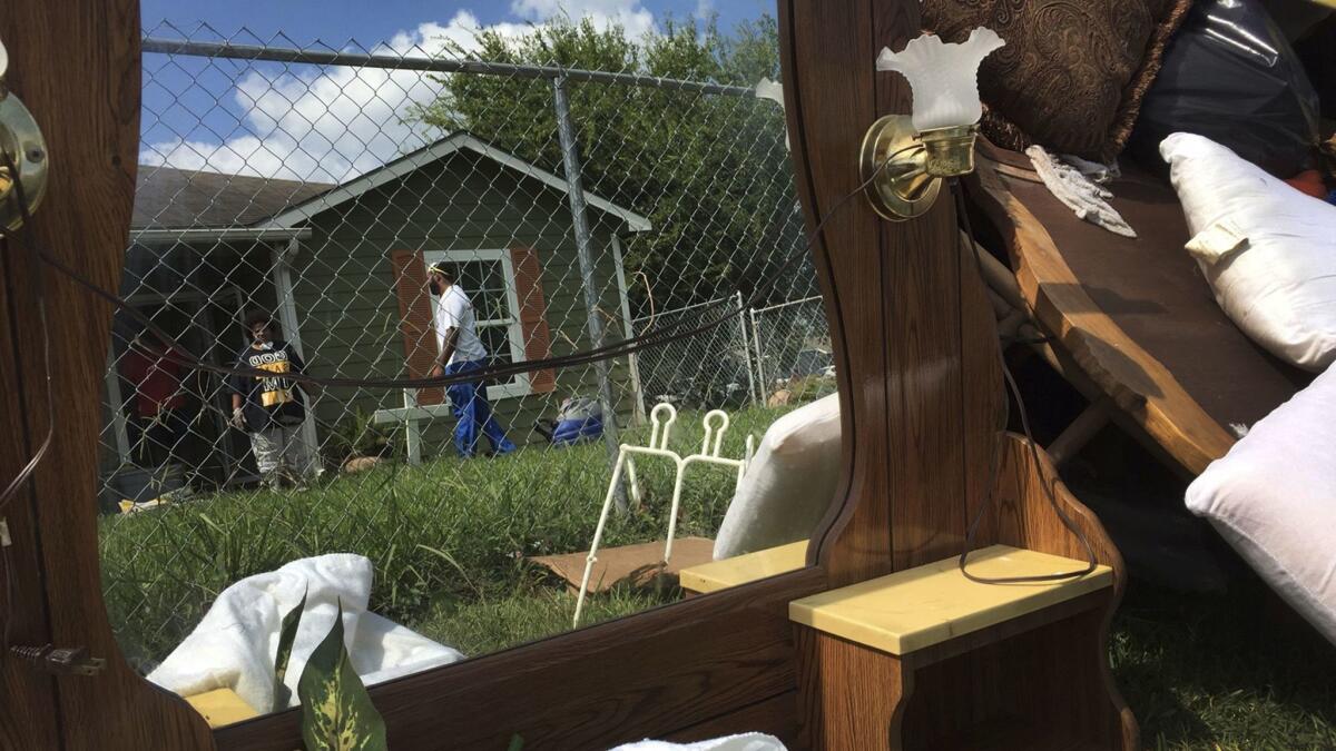 Maxine Williams and Steven Williams spent all day trying to clean out Evelyne Bowie's home. It was flooded after Hurricane Harvey struck the Gulf Coast and flooded the town of Port Arthur.