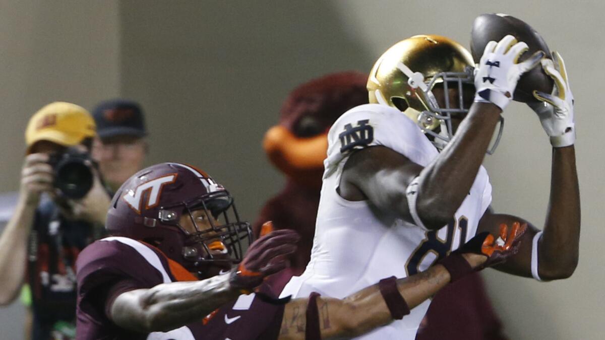 Notre Dame wide receiver Miles Boykin (81) makes a catch over Virginia Tech defensive back Jovonn Quillen (26) during the second half on Saturday. Notre Dame won 45-23.