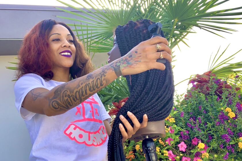 Cosmetologist and TikToker Sharly Parker styles a wig that she made.