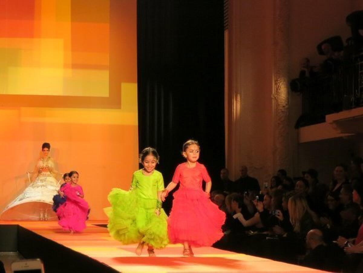 Four colorfully clad children race along Jean Paul Gaultier's runway on Wednesday before a model clad as a bride.
