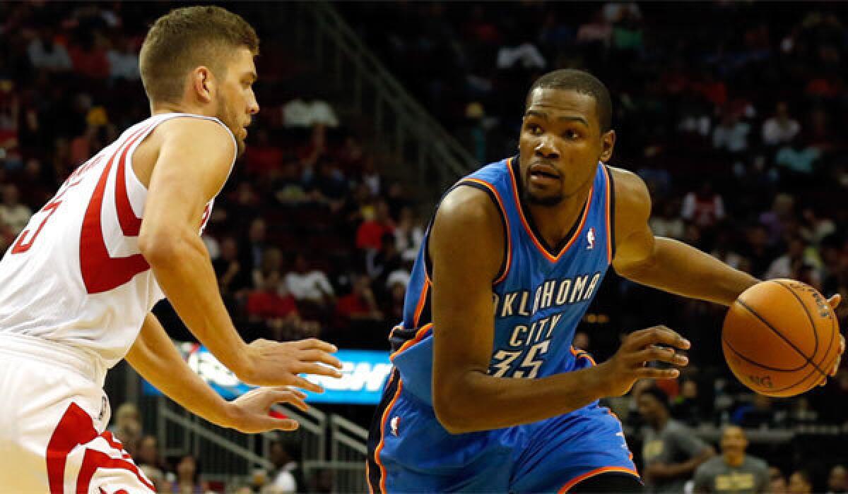 Oklahoma City's Kevin Durant drives to the basket against Houston's Chandler Parsons.