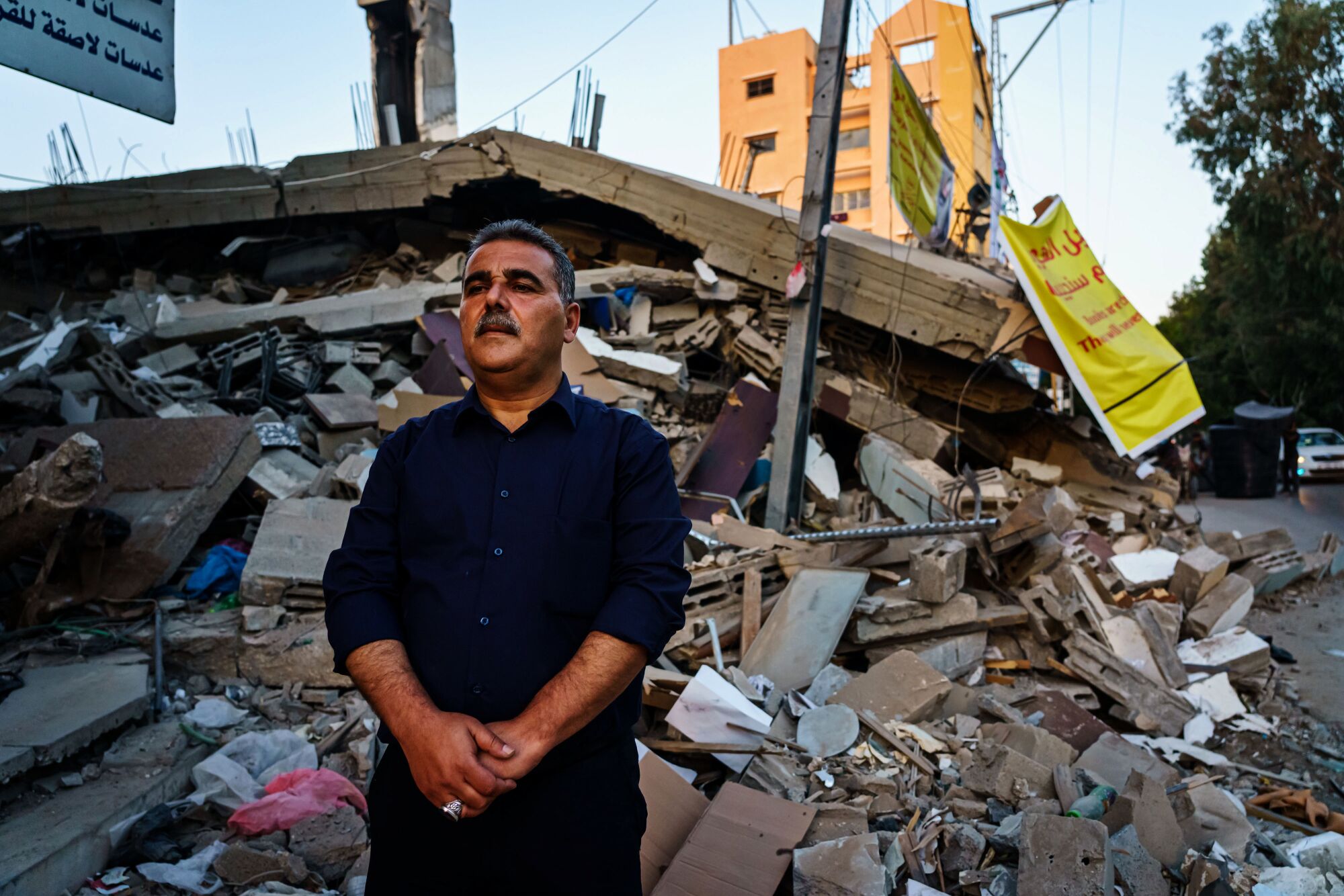 Samir Mansour before the ruins of his bookstore