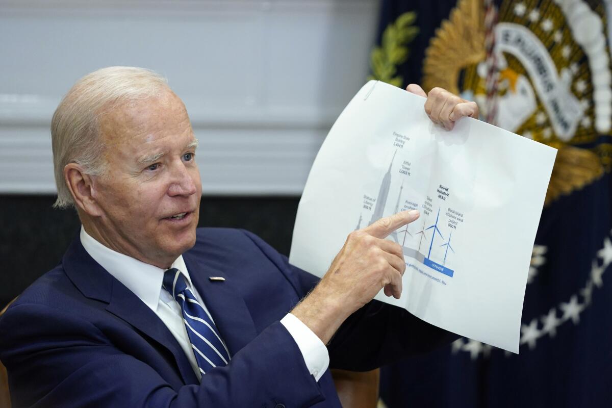 A man holds up a piece of paper.