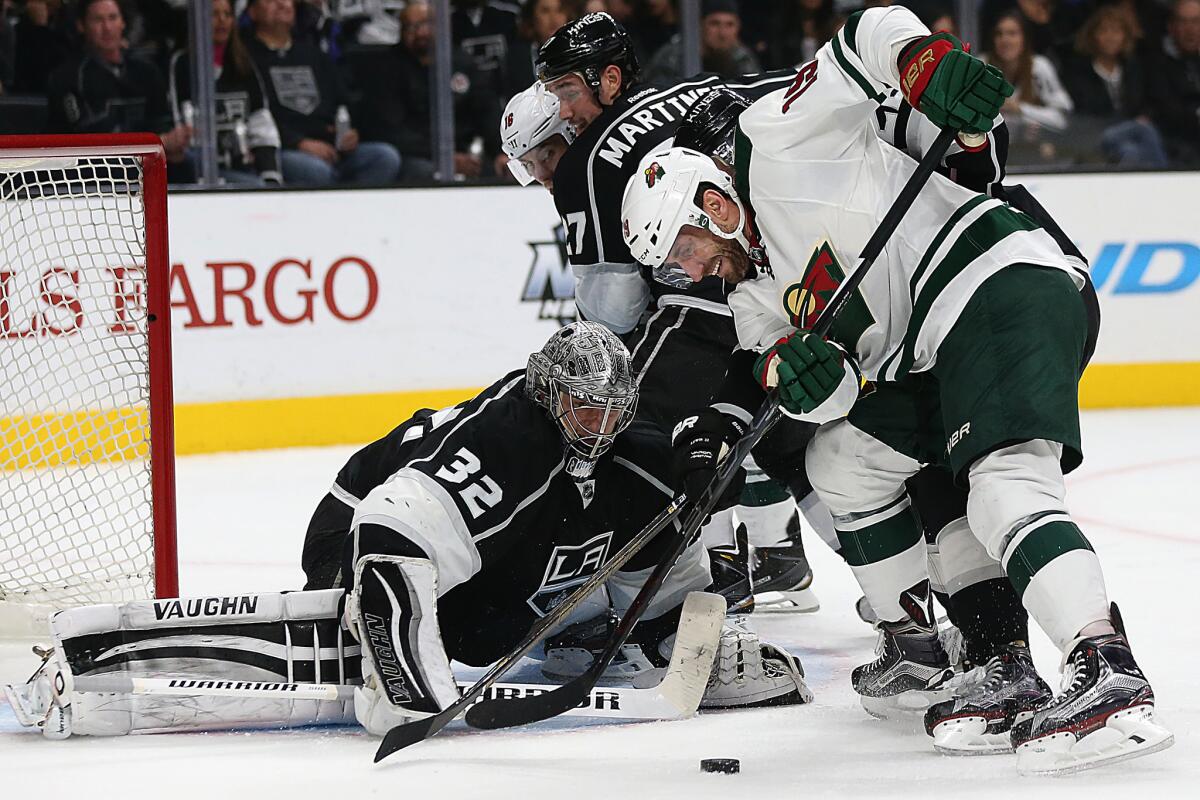 Minnesota center Jarret Stoll tries to shoot on Kings goalie Jonathan Quick.