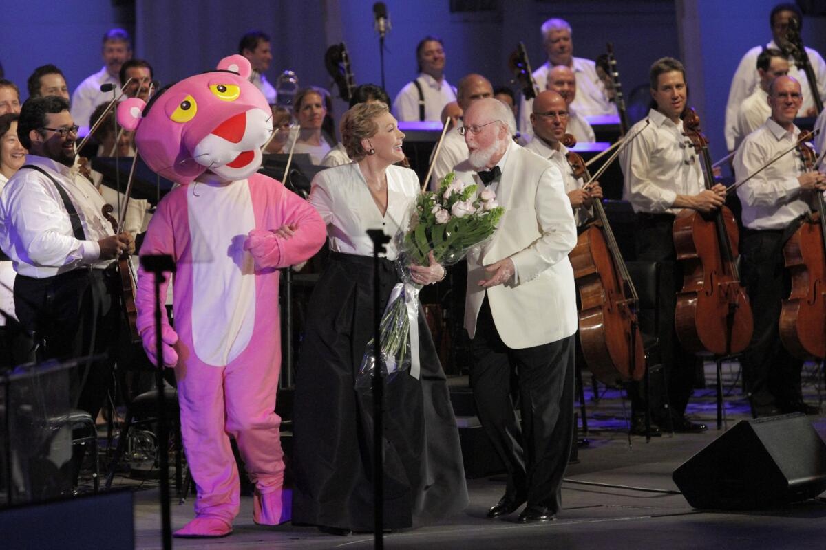 The Pink Panther character poses with Julie Andrews and composer/conductor John Williams after a tribute to director Blake Edwards and composer Henry Mancini at the Hollywood Bowl.