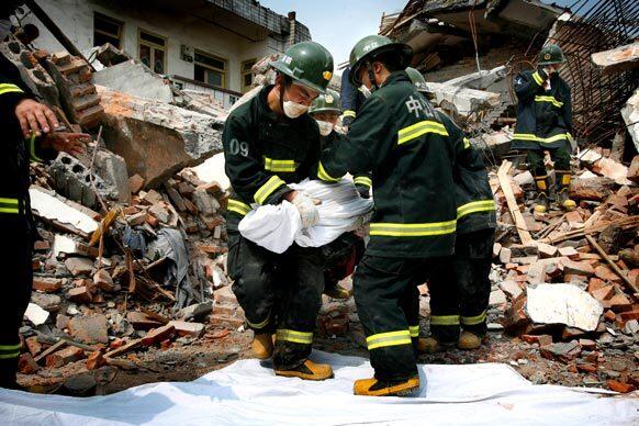 Rescue workers in Hanwang, China, retrieve the body of another earthquake victim. Nearly 21,000 people remain missing more than two weeks after the quake struck Sichuan province on May 12.