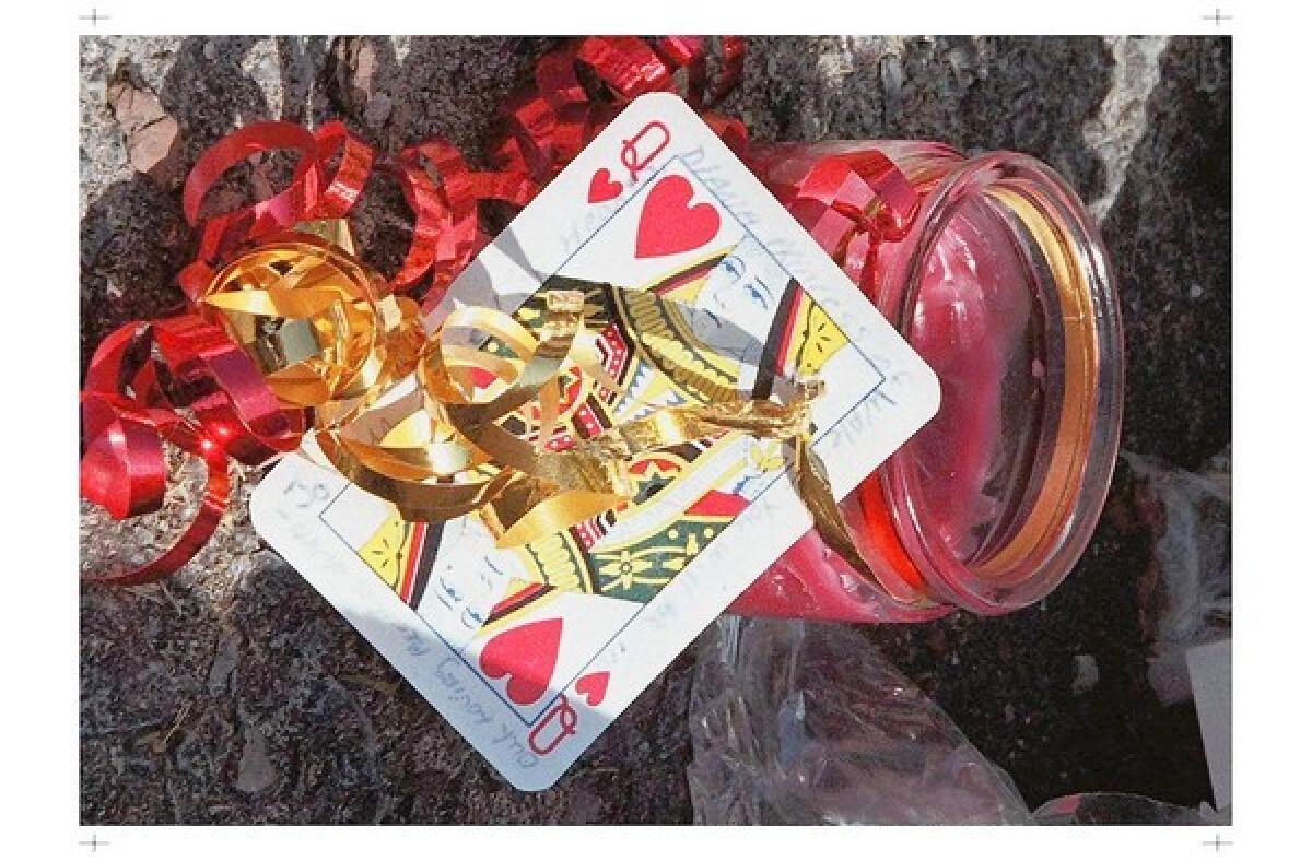 A queen of hearts card, bound to a candle with ribbon, below, sits on ground outside home of Canada's governor general in Ottawa in honor of Diana, Princess of Wales, after her death in 1997.