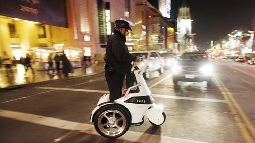 LAPD reserve officer Paul Martinez rides an electric vehicle across Hollywood Boulevard. Forty-four civilian officers - including a pilot, a preacher, an attorney and a movie executive - showed up for Saturday night's show of force.