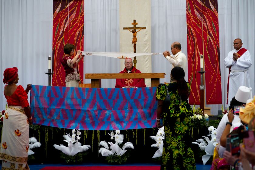 Various catholic communities drape the altar with native clothing during the San Diego Diocese’s sixth annual Pentecost Mass for All People at Mira Mesa on Saturday, May 27, 2023. The celebration brings together more than two dozen cultural communities from the Americas and around the world. Participating cultures include Africans, African Americans, Chinese, Filipinos, Germans, Hispanics, Indians, Indonesians, Irish, Italian, Korean, Laotian, Mexican, Native American, Samoan, Tongan, Ukrainian and Vietnamese.