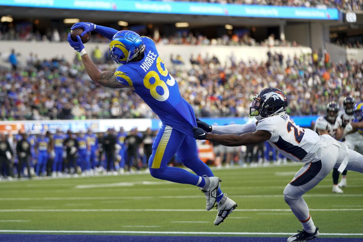 Rams tight end Tyler Higbee catches a touchdown pass in front of Denver Broncos cornerback Damarri Mathis.