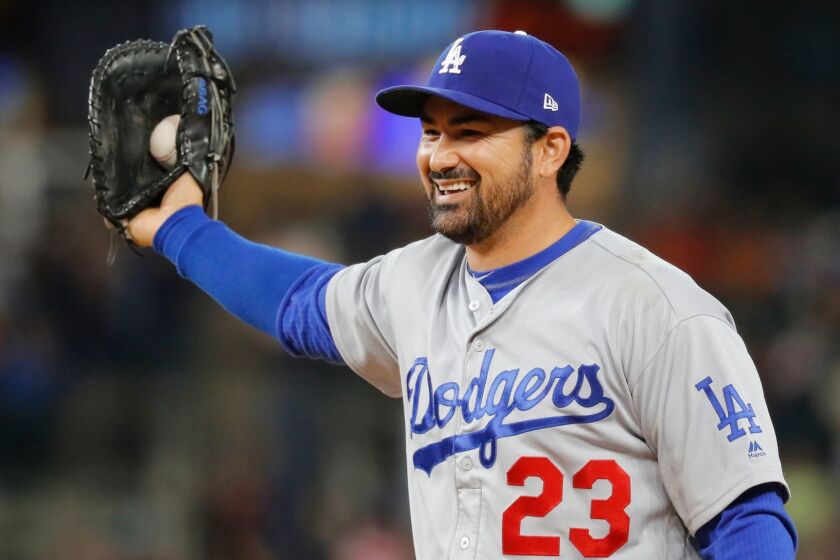 FILE - In this Aug. 18, 2017, file photo, Los Angeles Dodgers first baseman Adrian Gonzalez smiles after catching a Detroit Tigers' Ian Kinsler line drive in the eighth inning of a baseball game, in Detroit. Free agent first baseman Adrian Gonzalez and the New York Mets have finalized a one-year contract for the $545,000 major league minimum. The 35-year-old batted .242 for the Los Angeles Dodgers last season, when he was limited to 71 games because of a herniated disk in his back. A five--time All-Star, Gonzalez has a .288 career average with 311 home runs in 14 major league seasons.(AP Photo/Paul Sancya, File)