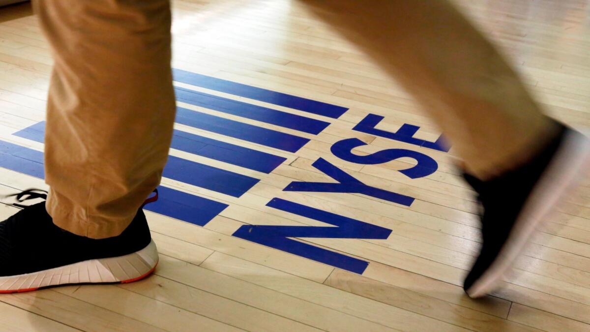 An "NYSE" logo adorns the entrance to the trading floor the New York Stock Exchange.
