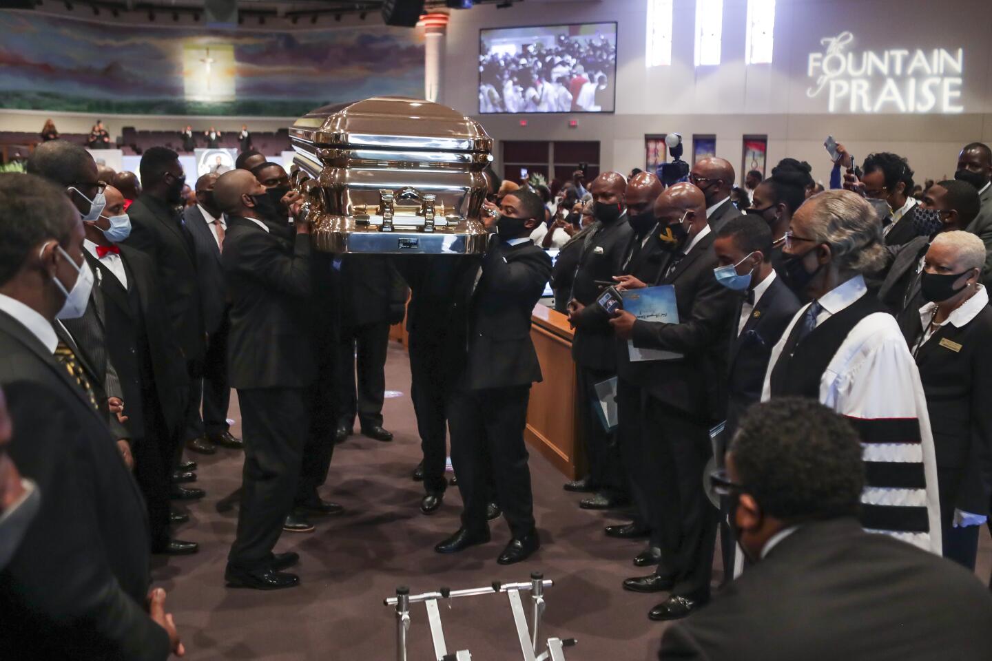 Pallbearers carry the casket following the funeral of George Floyd June 9, 2020, at The Fountain of Praise church in Houston. - George Floyd will be laid to rest Tuesday in his Houston hometown, the culmination of a long farewell to the 46-year-old African American whose death in custody ignited global protests against police brutality and racism. Thousands of well-wishers filed past Floyd's coffin in a public viewing a day earlier, as a court set bail at $1 million for the white officer charged with his murder last month in Minneapolis. (Photo by Godofredo A. VASQUEZ / POOL / AFP) (Photo by GODOFREDO A. VASQUEZ/POOL/AFP via Getty Images)