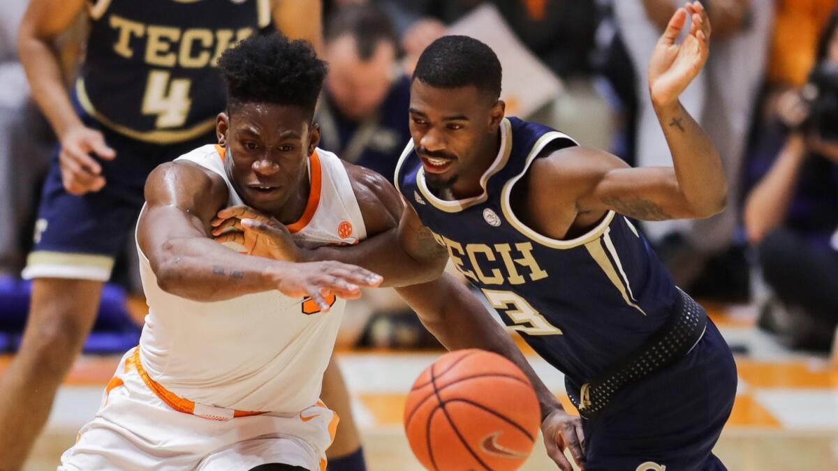 Admiral Schofield of the Tennessee Volunteers and Curtis Haywood of the Georgia Tech Yellow Jackets go after a loose ball.