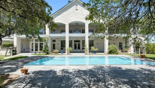 The 2.6-acre estate holds a 9,600-square-foot home, a grassy yard with a pool and a 600-square-foot stone wine cellar.