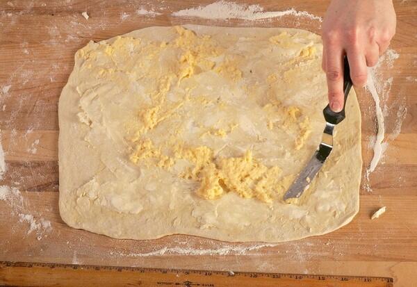 Spread the margarine and sugar mixture, and the custard, over the dough.