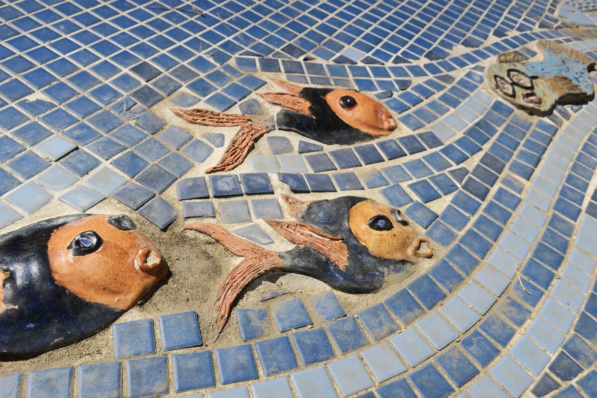 The fountain at Mayors' Discovery Park in La Cañada uses low-relief ceramic sculptures created by local ceramics students to entice children to play and imagine themselves in a marine environment.