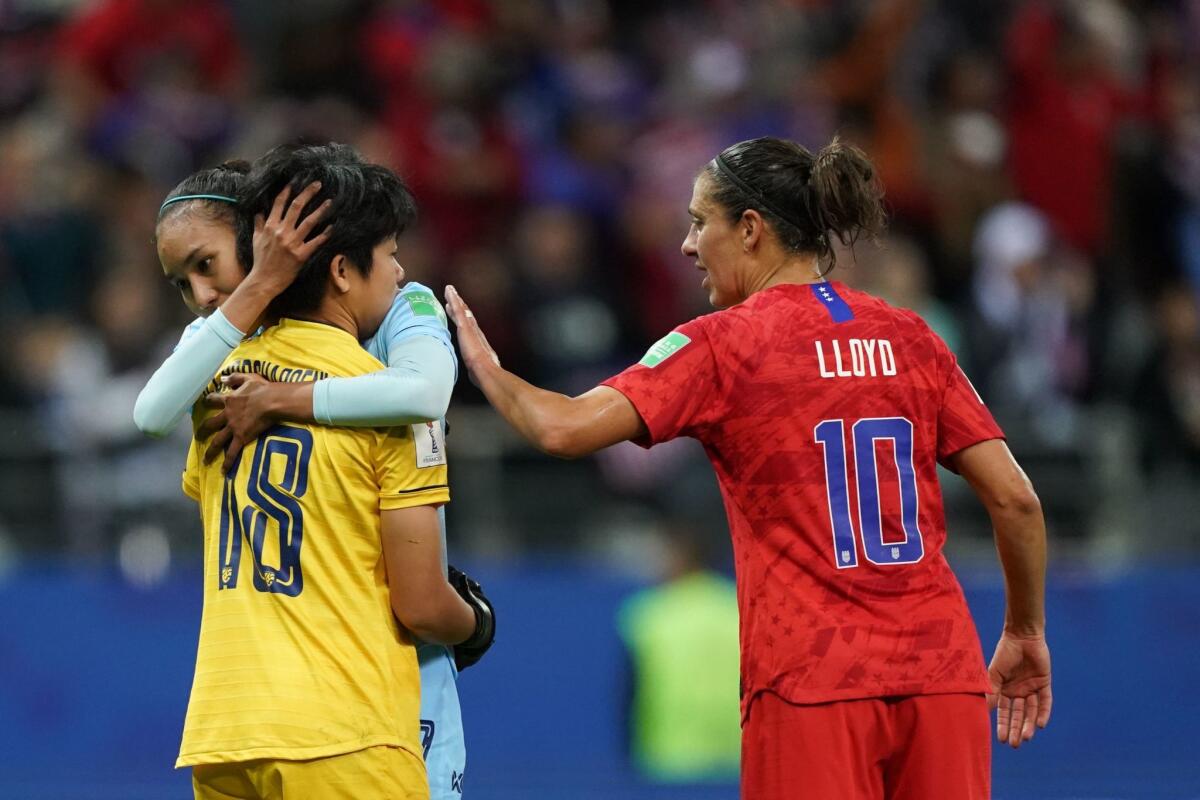 United States' forward Carli Lloyd (R) and Thailand's goalkeeper Sukanya Chor Charoenying (L) react after the France 2019 Women's World Cup Group F football match between USA and Thailand, on June 11, 2019, at the Auguste-Delaune Stadium in Reims, eastern France.