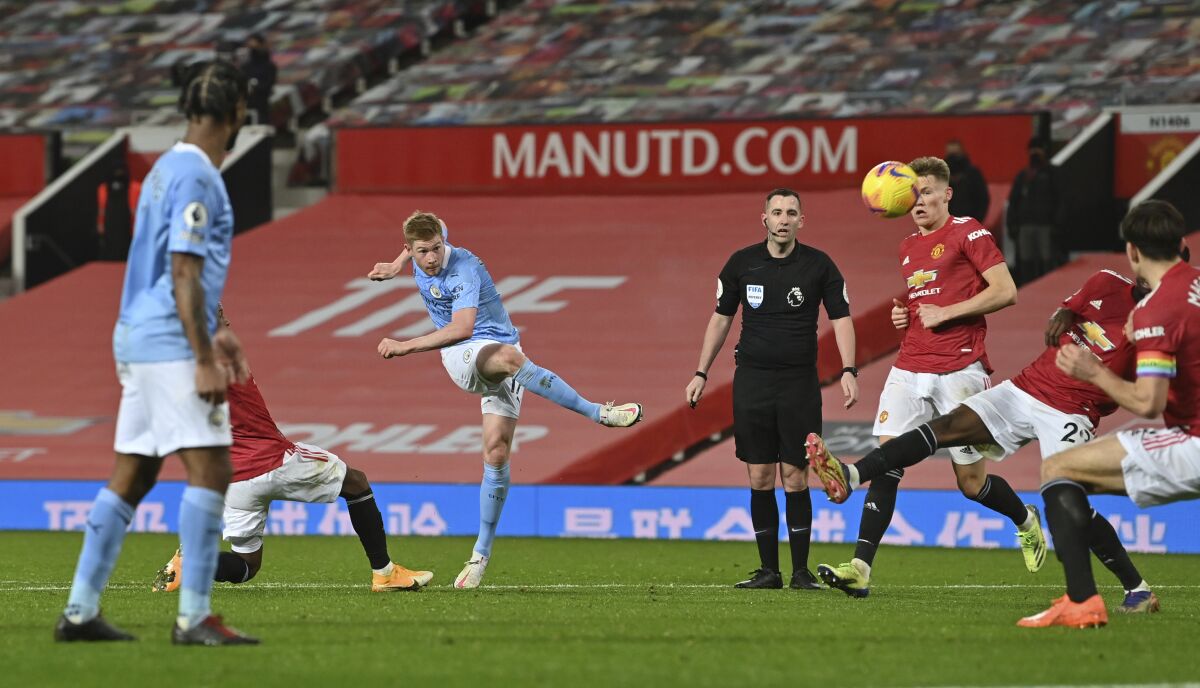 Manchester City's Kevin De Bruyne takes a shot at goal during the English Premier League soccer match between Manchester United and Manchester City at Old Trafford in Manchester, England. Saturday, Dec. 12, 2020. There have been 150 top-flight Man U v Man City derbies with United having won 58 and City 45, with 47 draws. (AP Photo/Paul Ellis/ Pool via AP)