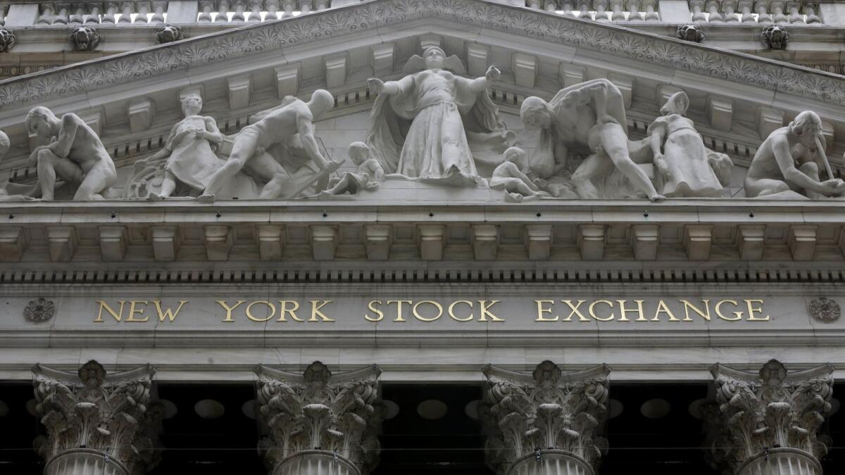 A late-in-the-session rally pulled the Dow Jones industrial average back from a 611-point loss Thursday.
