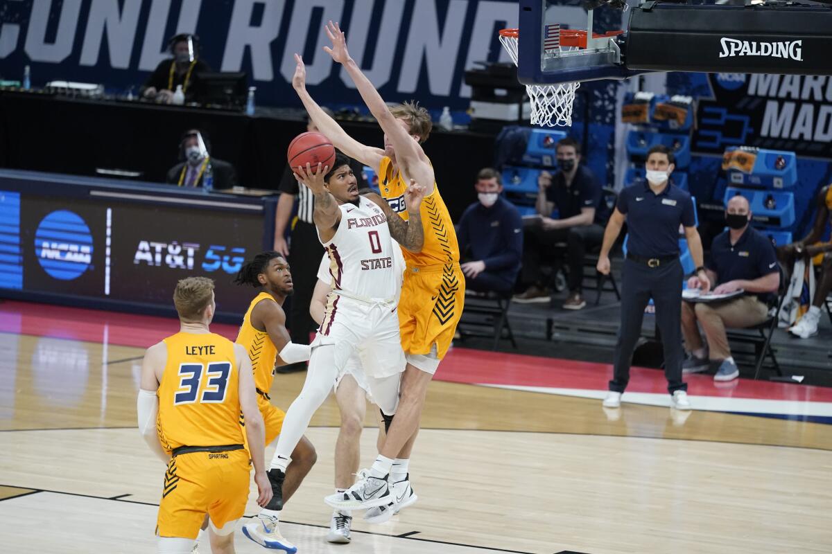 Florida State's RayQuan Evans puts up a shot against UNC-Greensboro's Hayden Koval.