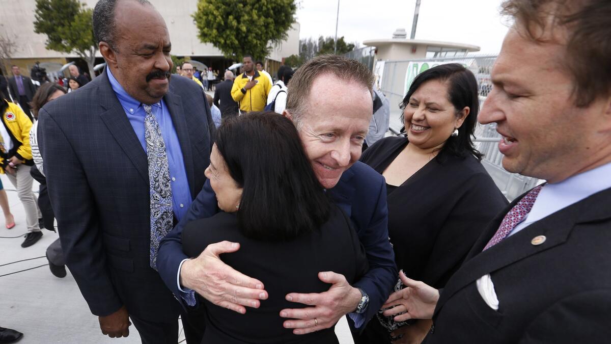 New Los Angeles Unified leader Austin Beutner hugs California Community Foundation President Antonia Hernández after he made his first remarks as superintendent at Belmont High School in Los Angeles.