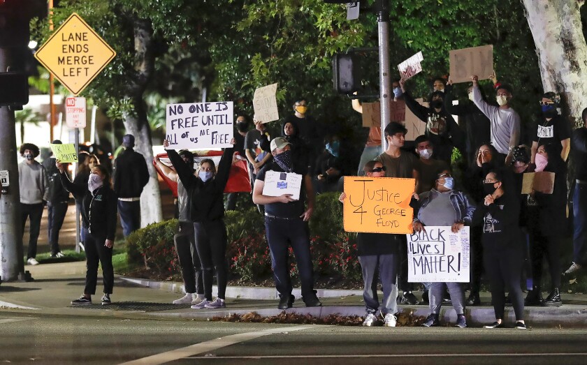 Protesters gathered outside of South Coast Plaza in Costa Mesa.