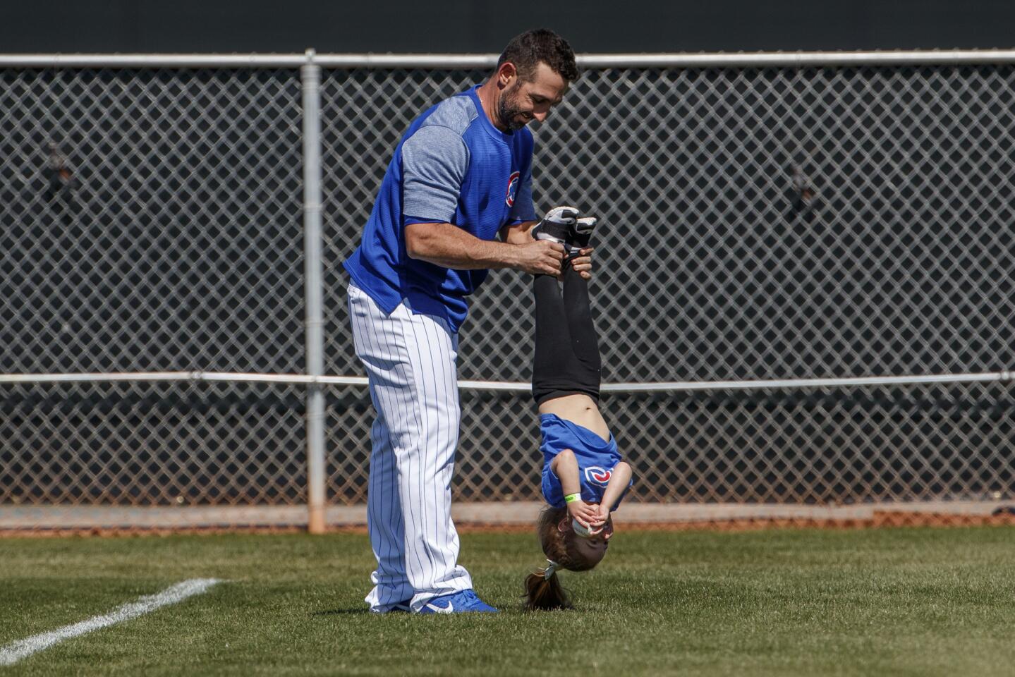 Daniel Descalso plays with his 2-year-old daughter Emilia before a Cactus League game against the Athletics at Sloan Park in Mesa, Ariz., on Thursday, Feb. 28, 2019.