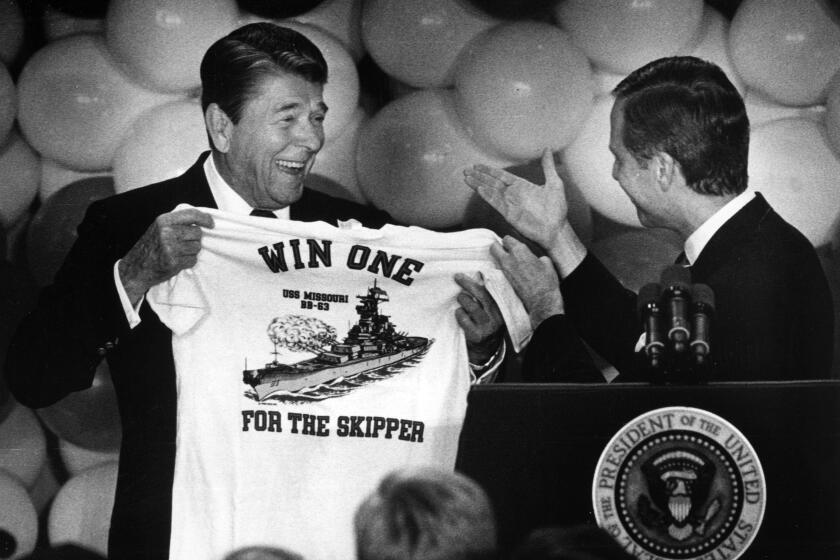 Aug. 23, 1988: President Ronald Reagan receives a "Win One for the Skipper" T?shirt from Senator Pete Wilson after a fund raising lunch for the senator at the Irvine Hilton Hotel.