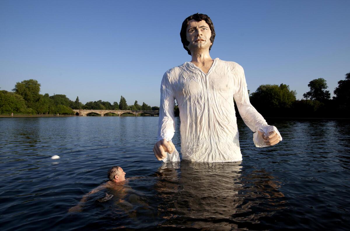 A statue of Colin Firth as Mr. Darcy rises above London's Serpentine Lake.