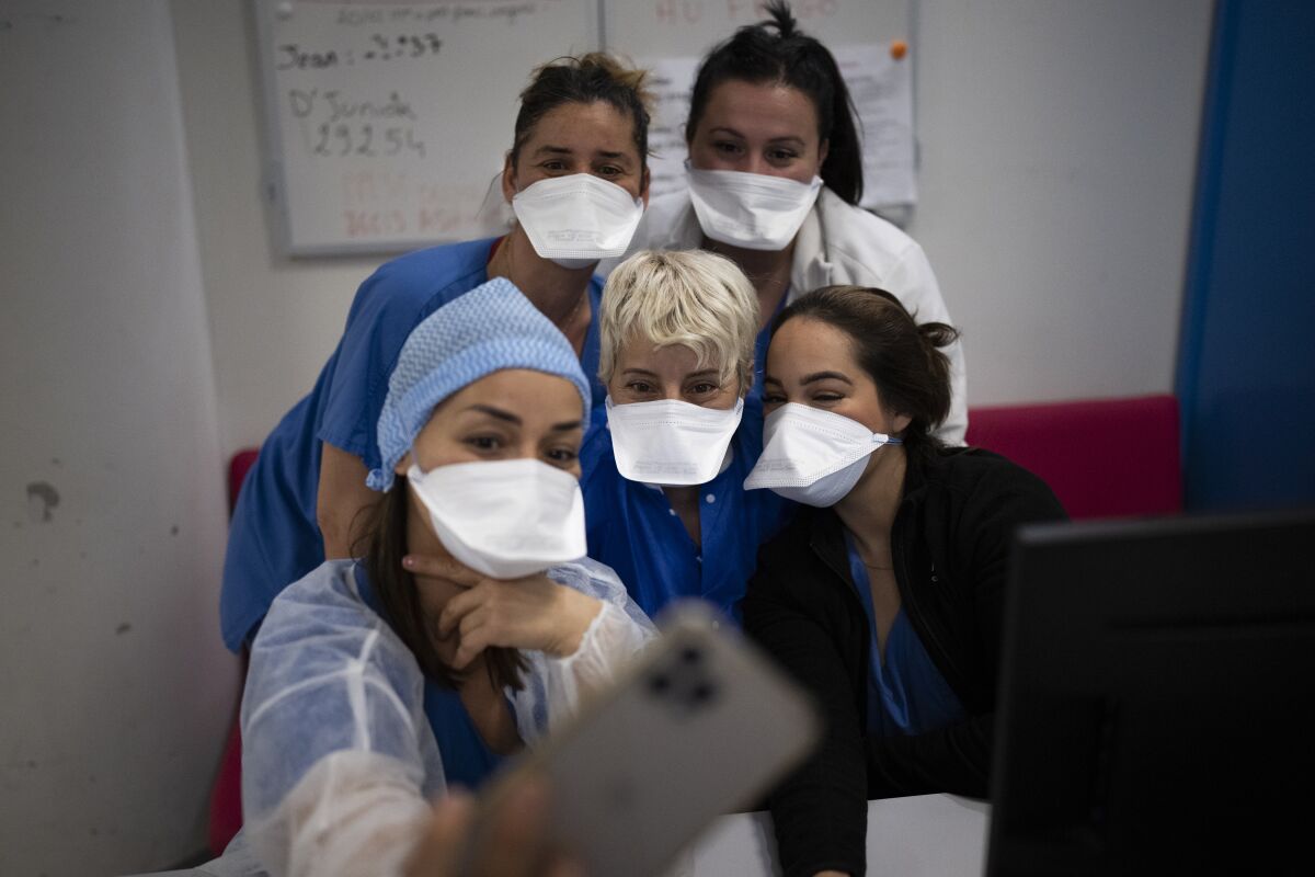 Hospital workers pose for a selfie in the COVID-19 ICU of La Timone Hospital in Marseille, southern France.