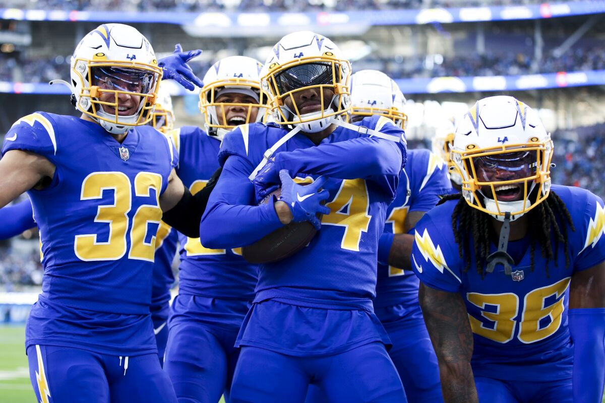 A group of Chargers players cheer.