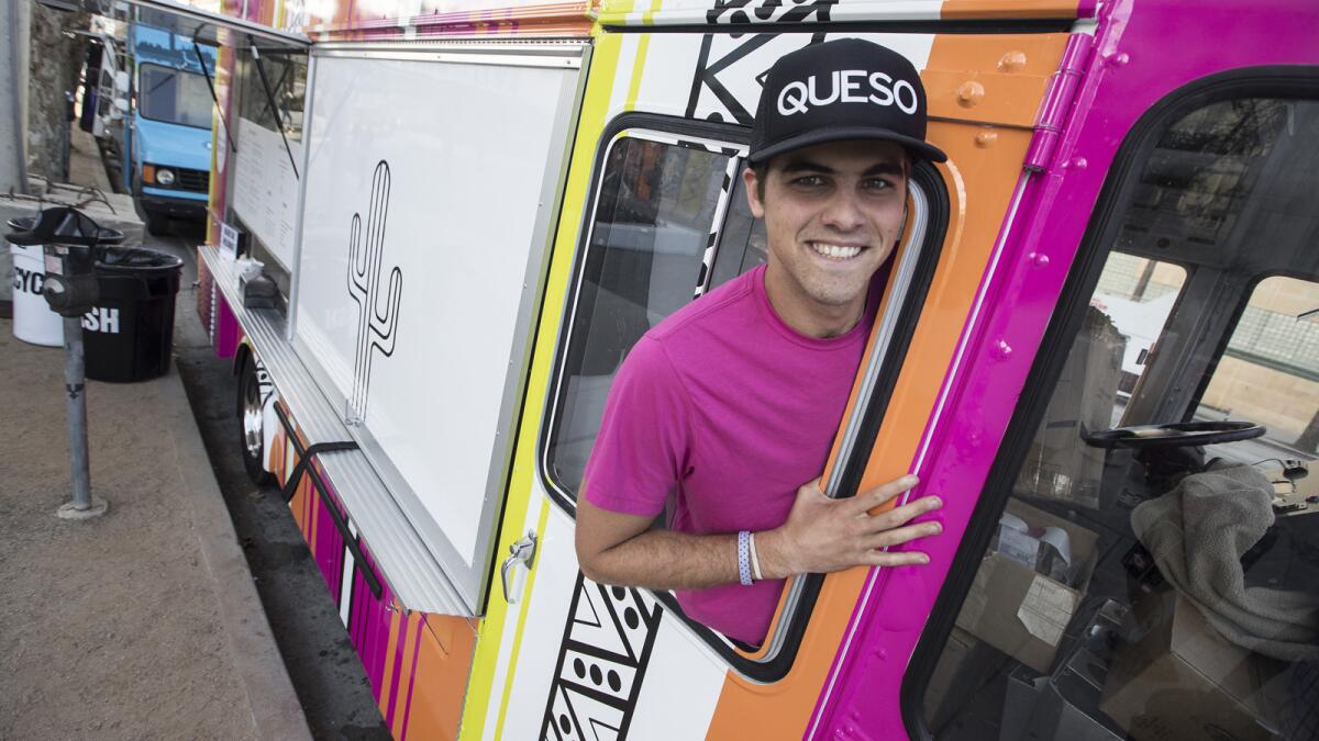 Beaux Hebert, the manager of the Queso Truck, poses for a photo on the truck.