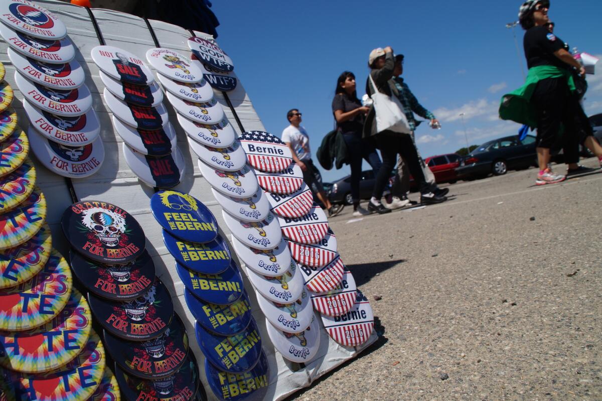 Vendors sold Bernie Sanders buttons and other memorabilia in the parking lot at Irvine Meadows Amphitheatre, where the Democratic presidential candidate led a rally Sunday.