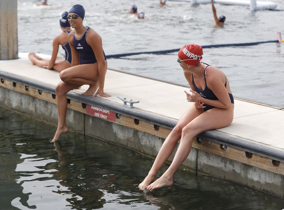 Two Newport Harbor girls are a bit reluctant as they prepare to jump into the cold water.