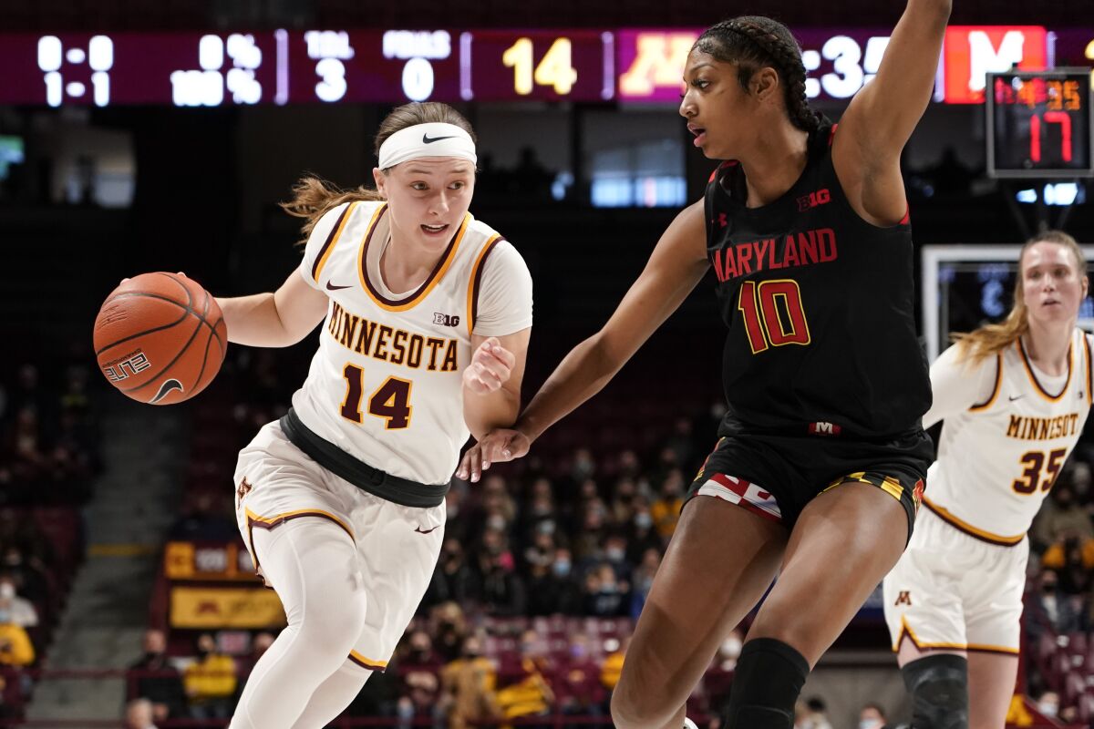Minnesota guard Sara Scalia (14) drives past Maryland guard Angel Reese during the first half an NCAA college basketball game Sunday Jan. 9, 2022, in Minneapolis. (AP Photo/Craig Lassig)