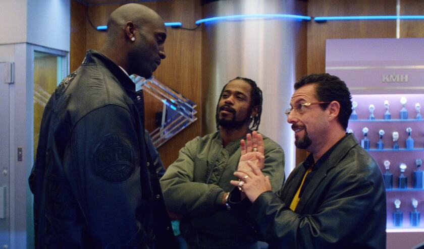 A scene from “Uncut Gems” with, from left, Kevin Garnett, Lakeith Stanfield and Adam Sandler.