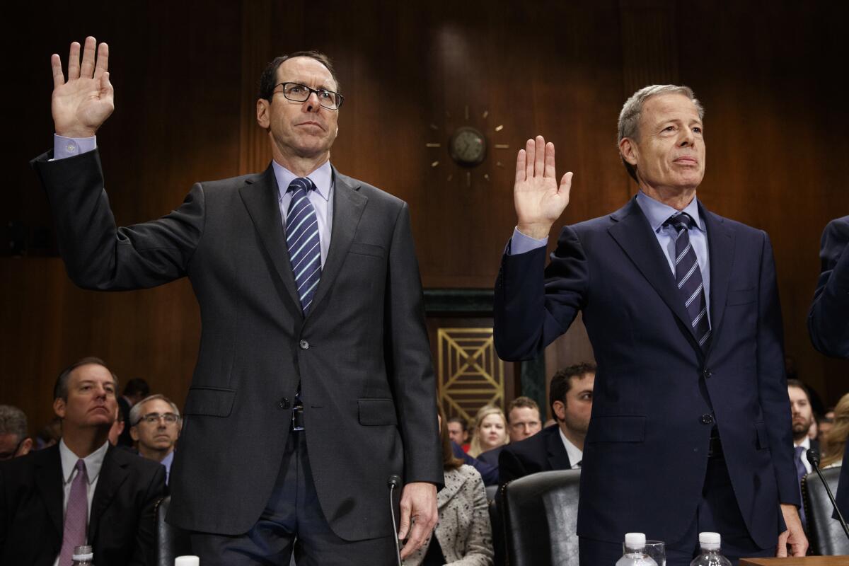 AT&T CEO Randall Stephenson, left, and Time Warner CEO Jeffrey Bewkes are sworn in on Capitol Hill prior to testifying before a Senate Judiciary subcommittee hearing on the proposed merger between AT&T and Time Warner.