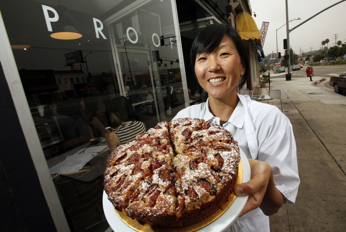 Na Young Ma, chef and owner of Proof Bakery in Atwater Village holds her fig oat cake.